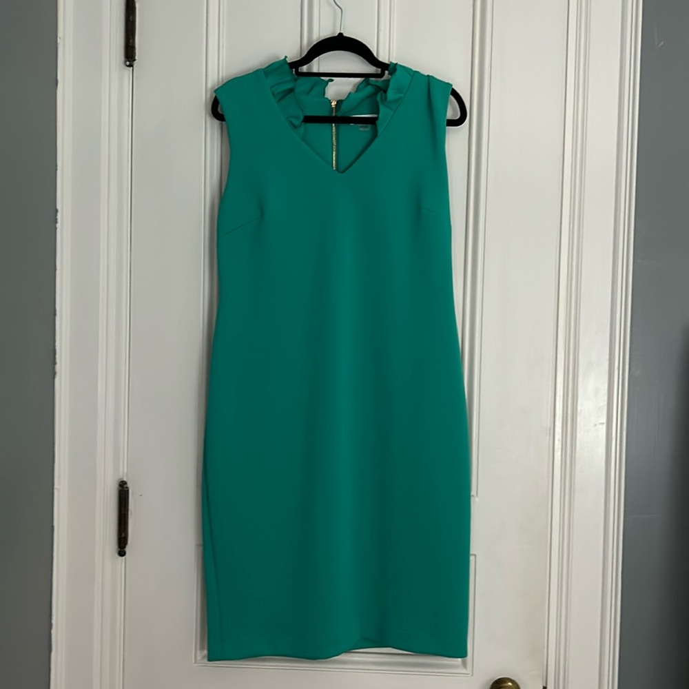 Sleeveless green Calvin Klein dress material is satin. Ruffle collar.